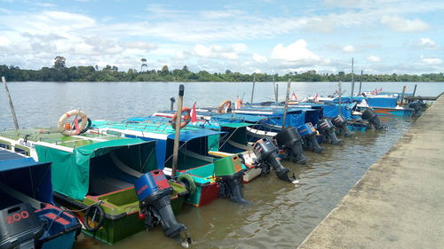 Boats moored in sea against sky