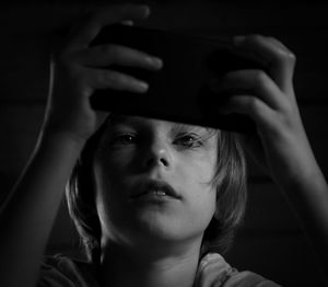 Close-up portrait of boy using mobile phone