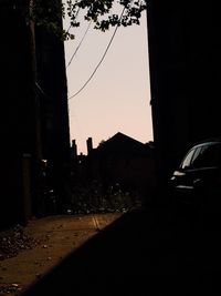 Cars on city street against clear sky