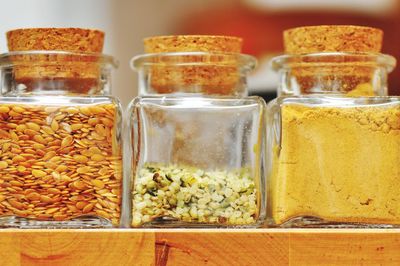 Close-up of raw food in jars on table