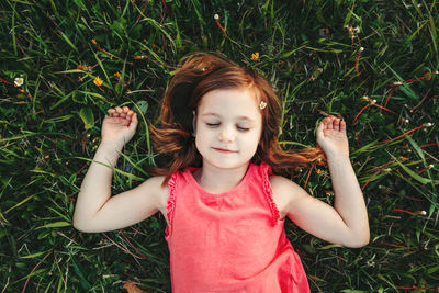 Cute girl lying on grass