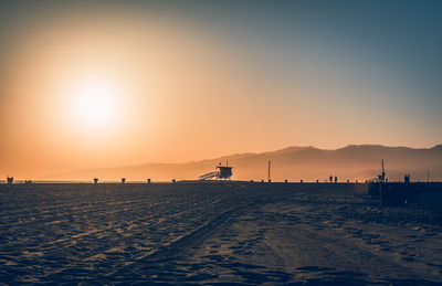 Scenic view of beach against sky during sunset