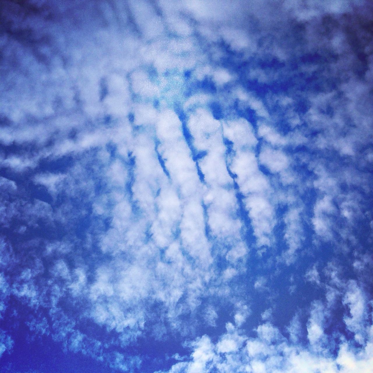 blue, low angle view, sky, cloud - sky, nature, sky only, white color, backgrounds, beauty in nature, tranquility, cloud, cloudy, full frame, outdoors, no people, day, white, cloudscape, scenics, vapor trail