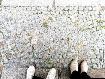 Low section of person standing on tiled floor