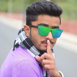 Portrait of young man wearing sunglasses outdoors