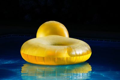 Close-up of yellow inflatable ring in swimming pool