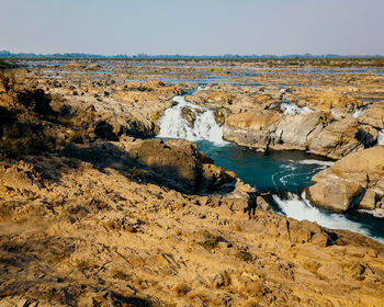 Aerial view of rocks on land against sky