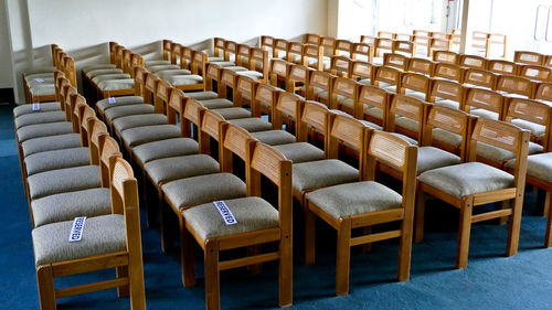 Empty chairs and tables in row