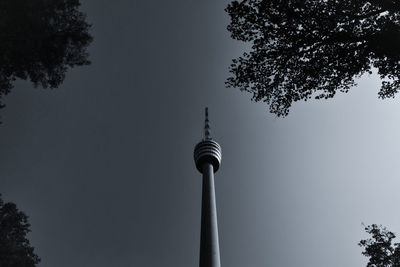 Low angle view of communications tower against sky