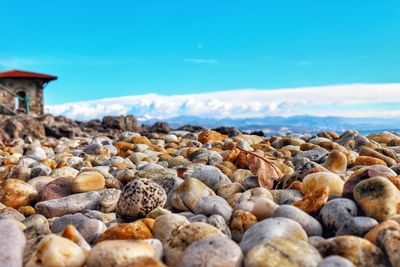 Surface level of pebble beach against sky