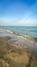 Scenic view of beach against blue sky