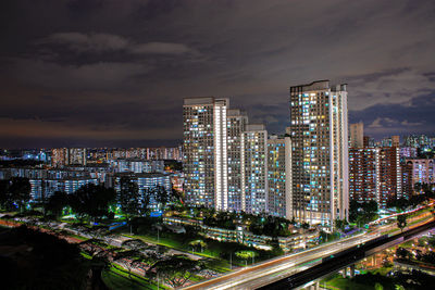 High angle view of illuminated buildings against sky at night