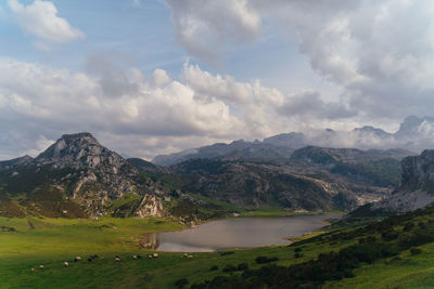 Scenic view of lake and mountains against sky