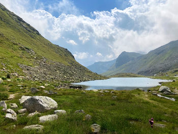 Scenic view of lake and mountains against sky
