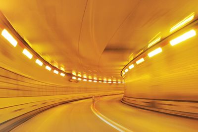Illuminated empty yellow tunnel