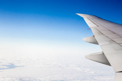 Cropped image of airplane flying in sky