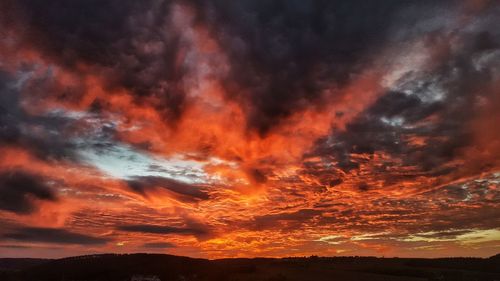 Low angle view of dramatic sky during sunset