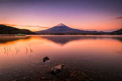 Reflection of mountains in lake during sunset