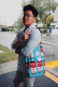 Full length of young man standing on road in city