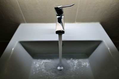 Close-up of faucet in bathroom