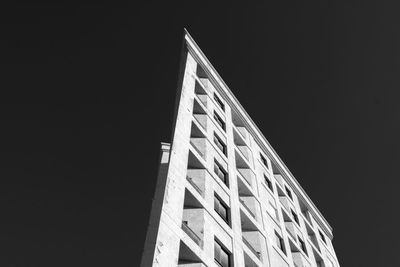 Low angle view of building against clear sky at night