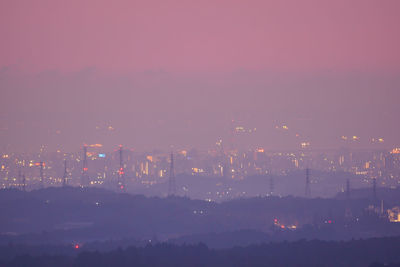 High angle view of illuminated buildings in city at night