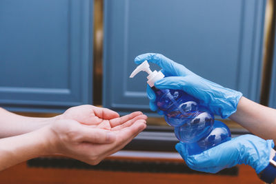 Close-up of woman holding hands and use alcohol gel 