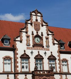 Low angle view of clock tower against sky