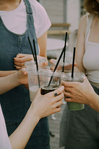 Midsection of woman holding drink