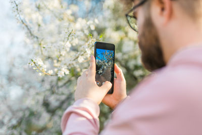 Midsection of woman using mobile phone