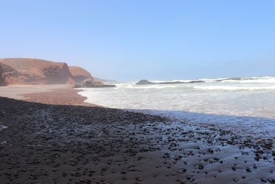 Scenic view of beach against clear sky