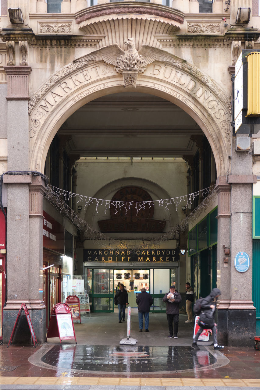 architecture, built structure, arch, building exterior, group of people, city, travel destinations, travel, tourism, men, adult, building, arcade, women, history, the past, tourist, day, lifestyles, transportation, outdoors, crowd, urban area, walking, full length, entrance, landmark