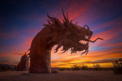 Statue against sky during sunset