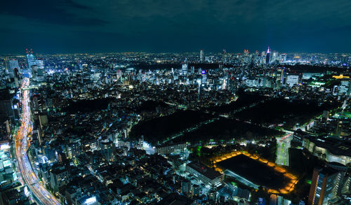 High angle view of city lit up at night