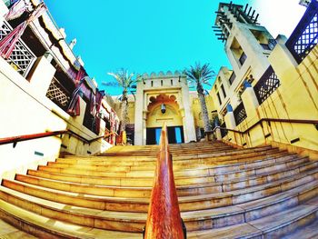 Low angle view of stairs against clear blue sky