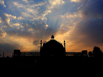 Silhouette of building against sky during sunset