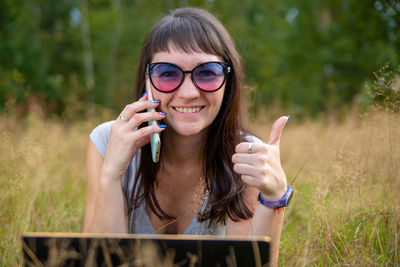 Portrait of young woman using mobile phone