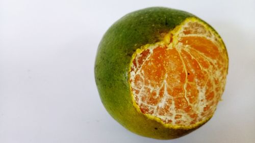 Close-up of orange slice against white background