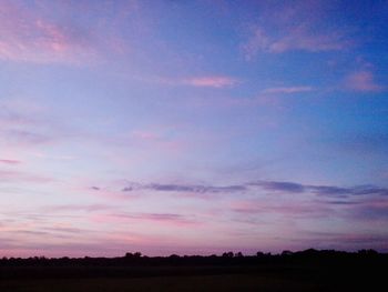 Scenic view of silhouette landscape against romantic sky