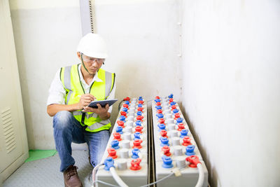 Man engineer in battery room in power plant for back up emergency case