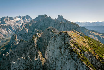 Aerial image of a group of climbers on top of mountain peak, gosaukamm, austria.