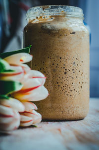 A jar of our sourdough with tulips from the garden in spring.