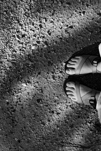 Low section of person standing on tiled floor