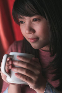 Portrait of young woman drinking coffee