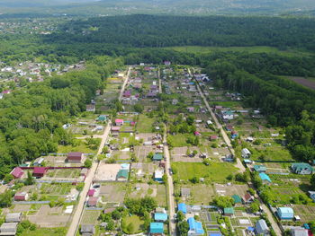 High angle view of trees and buildings in city