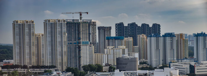 Modern buildings in city against sky