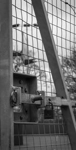 Close-up of metal grate against sky