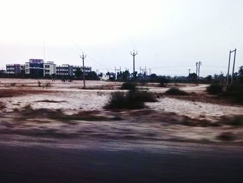 Road by city against clear sky