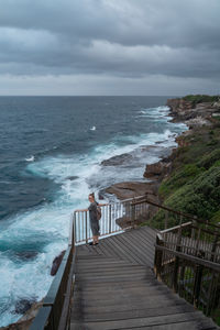 Man looking at sea against sky