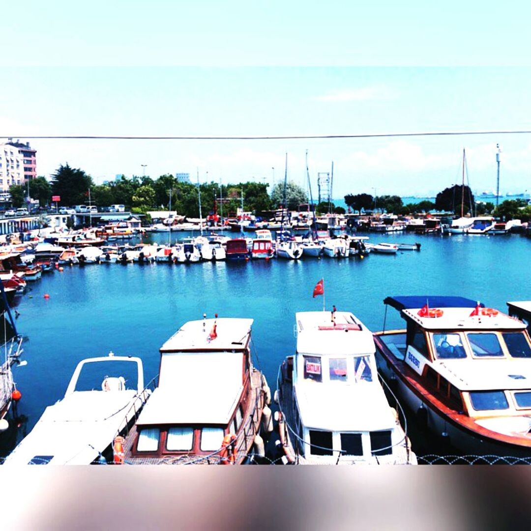 nautical vessel, water, moored, boat, transportation, built structure, architecture, mode of transport, building exterior, harbor, sea, clear sky, sky, blue, residential structure, day, residential building, city, river, reflection